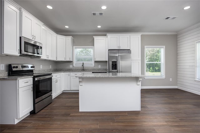 16011 S County Road 325, Hawthorne, FL 32640 - kitchen featuring stainless steel appliances, ornamental molding, plenty of natural light, a kitchen island, and white cabinets
