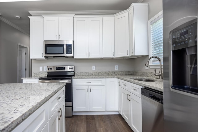 16011 S County Road 325, Hawthorne, FL 32640 - kitchen featuring appliances with stainless steel finishes, white cabinetry, ornamental molding, dark wood-type flooring, and light stone countertops