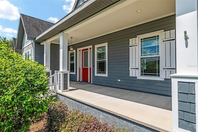 2556 SW 118th Ter, Gainesville, FL 32608 - property entrance with a porch and a shingled roof