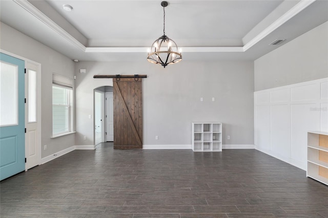 2556 SW 118th Ter, Gainesville, FL 32608 - spare room with a barn door, a tray ceiling, a chandelier, and dark wood-type flooring