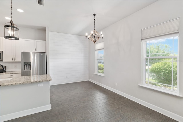2556 SW 118th Ter, Gainesville, FL 32608 - kitchen with stainless steel appliances, a chandelier, white cabinetry, dark wood-style flooring, and pendant lighting