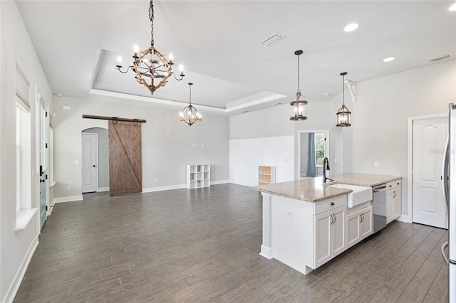 2556 SW 118th Ter, Gainesville, FL 32608 - kitchen featuring appliances with stainless steel finishes, a raised ceiling, a barn door, a chandelier, and recessed lighting