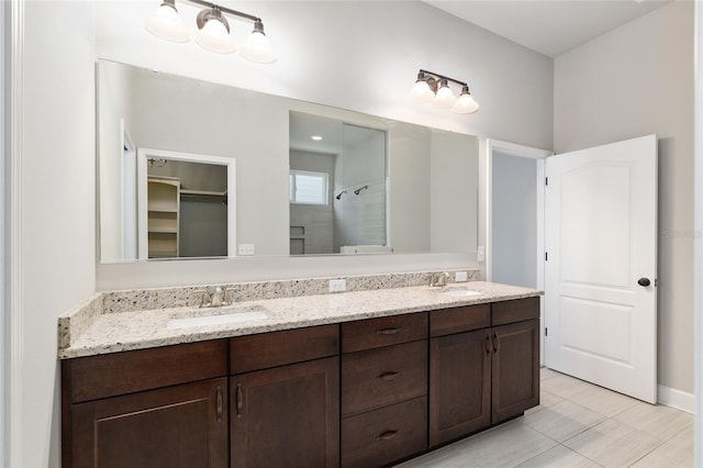 2556 SW 118th Ter, Gainesville, FL 32608 - full bath featuring double vanity, a tile shower, tile patterned floors, and a walk in closet
