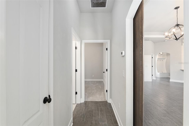 2556 SW 118th Ter, Gainesville, FL 32608 - hall featuring arched walkways, a chandelier, and dark wood finished floors