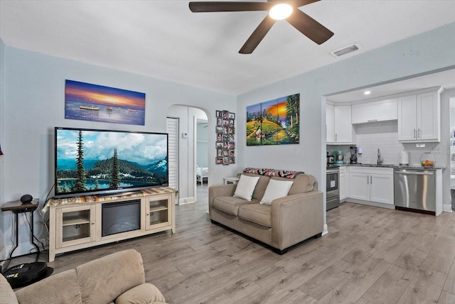 4444 5th Ave S, Saint Petersburg, FL 33711 - living room with arched walkways, light wood-style flooring, and ceiling fan