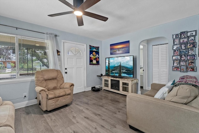 4444 5th Ave S, Saint Petersburg, FL 33711 - living area featuring arched walkways, ceiling fan, and wood finished floors