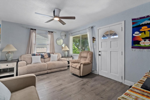 4444 5th Ave S, Saint Petersburg, FL 33711 - living room with wood finished floors, ceiling fan, and a textured wall