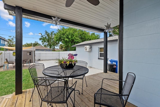 4444 5th Ave S, Saint Petersburg, FL 33711 - wooden terrace with a fenced backyard, a storage unit, a ceiling fan, and outdoor dining area