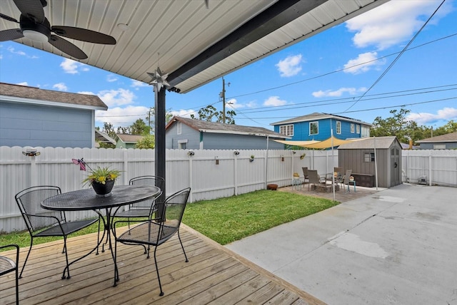 4444 5th Ave S, Saint Petersburg, FL 33711 - wooden deck featuring outdoor dining space, a storage unit, a fenced backyard, a patio, and a ceiling fan