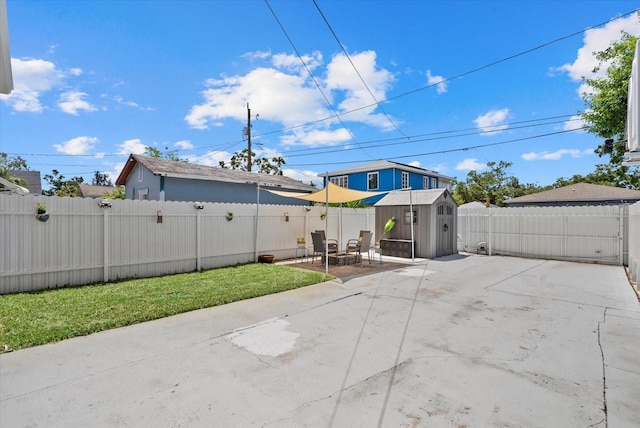 4444 5th Ave S, Saint Petersburg, FL 33711 - fenced backyard featuring a patio and a storage shed