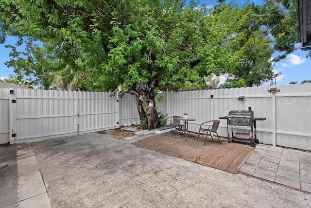 4444 5th Ave S, Saint Petersburg, FL 33711 - fenced backyard featuring a gate, area for grilling, and a wooden deck