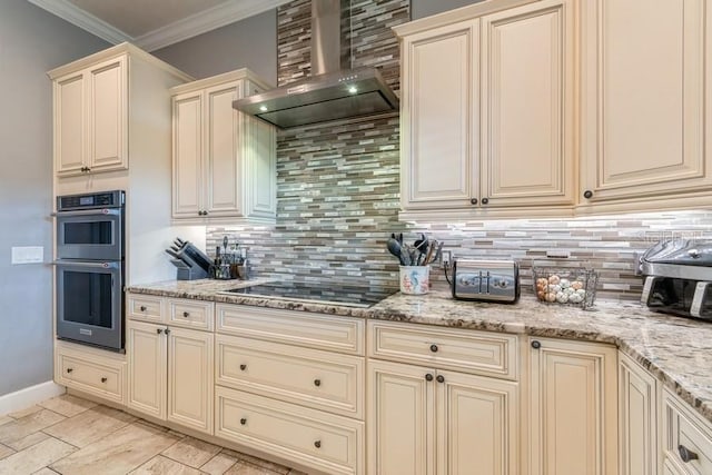 6813 SW 83rd Ter, Lake Butler, FL 32054 - kitchen with cream cabinets, wall chimney range hood, black electric cooktop, double oven, and decorative backsplash
