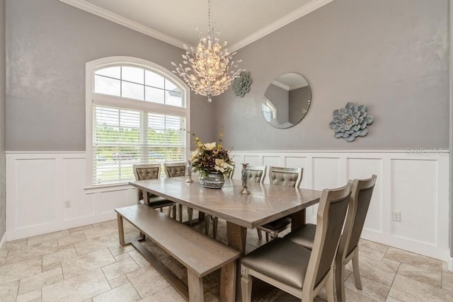 6813 SW 83rd Ter, Lake Butler, FL 32054 - dining area with a decorative wall, stone tile floors, ornamental molding, a chandelier, and a wainscoted wall