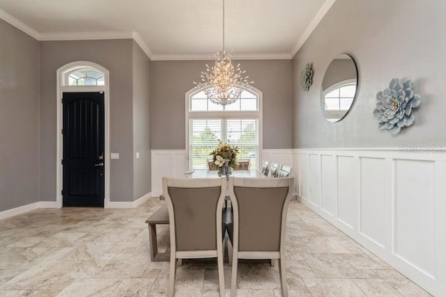 6813 SW 83rd Ter, Lake Butler, FL 32054 - dining room with a chandelier, a decorative wall, crown molding, a wainscoted wall, and light stone finish flooring