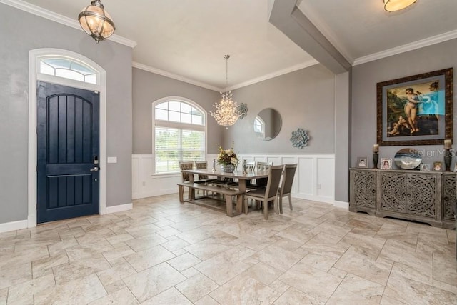 6813 SW 83rd Ter, Lake Butler, FL 32054 - foyer with stone tile flooring, crown molding, a decorative wall, a chandelier, and a wainscoted wall