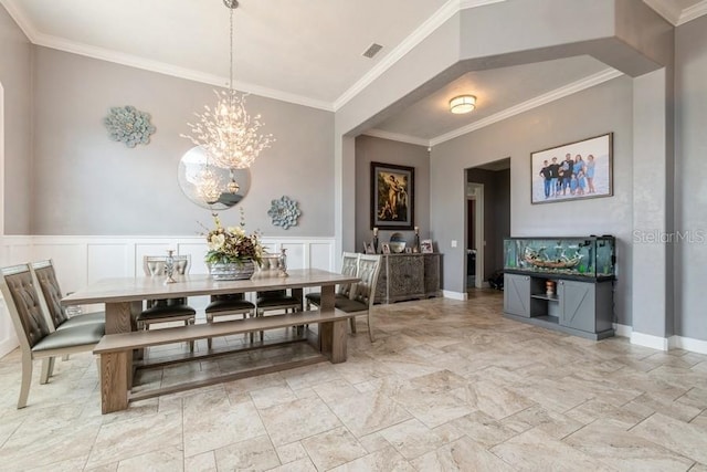 6813 SW 83rd Ter, Lake Butler, FL 32054 - dining space with crown molding, a chandelier, and wainscoting