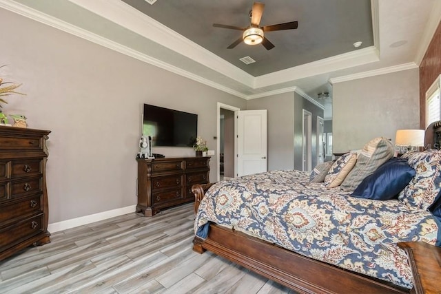 6813 SW 83rd Ter, Lake Butler, FL 32054 - bedroom with a raised ceiling, light wood-style flooring, and a ceiling fan