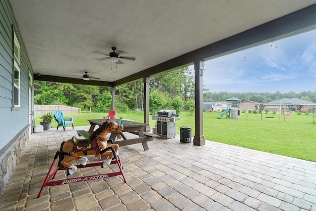 6813 SW 83rd Ter, Lake Butler, FL 32054 - fenced backyard with a playground, a patio, outdoor dining area, ceiling fan, and grilling area