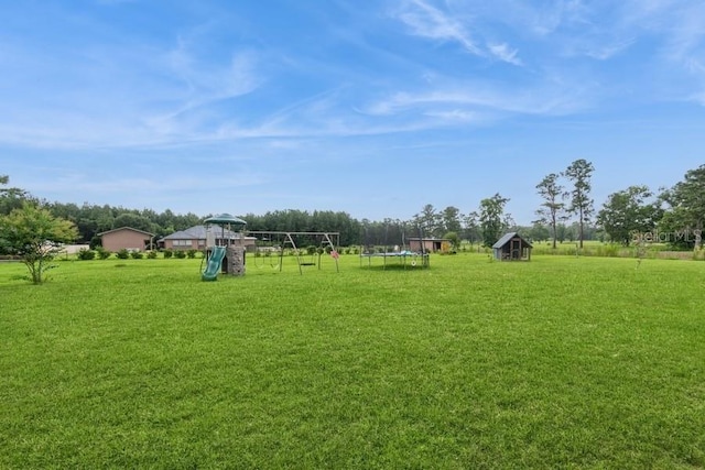 6813 SW 83rd Ter, Lake Butler, FL 32054 - view of grassy yard with a playground and a trampoline