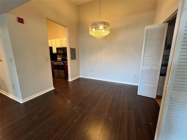 2360 SW Archer Rd Unit 719, Gainesville, FL 32608 - unfurnished dining area featuring dark wood-style floors, a chandelier, a towering ceiling, and electric panel