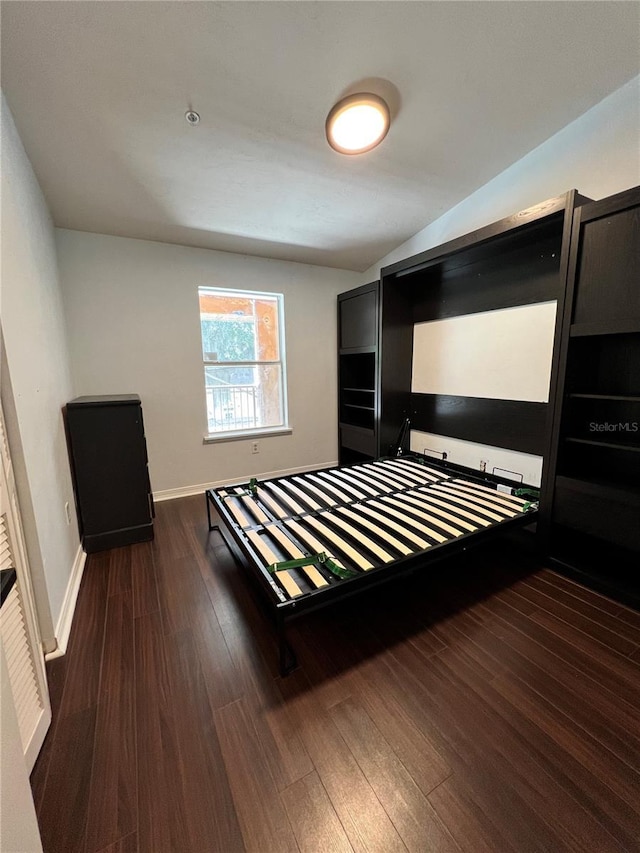 2360 SW Archer Rd Unit 719, Gainesville, FL 32608 - bedroom with dark wood-style floors and baseboards