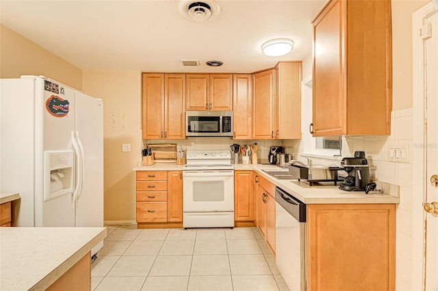 1318 NW 7th Rd, Gainesville, FL 32603 - kitchen featuring appliances with stainless steel finishes, light countertops, and light brown cabinets