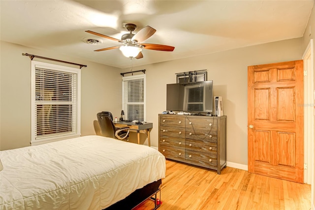 1318 NW 7th Rd, Gainesville, FL 32603 - bedroom with light wood finished floors and ceiling fan