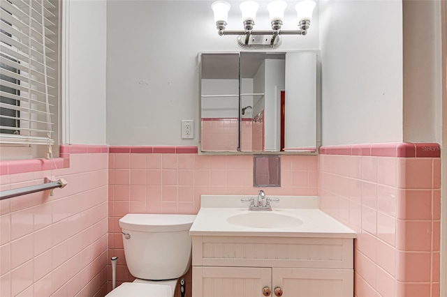 1318 NW 7th Rd, Gainesville, FL 32603 - bathroom featuring tile walls, vanity, and a wainscoted wall