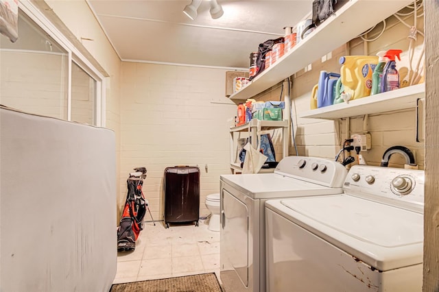 1318 NW 7th Rd, Gainesville, FL 32603 - laundry area with washer and clothes dryer and light tile patterned floors