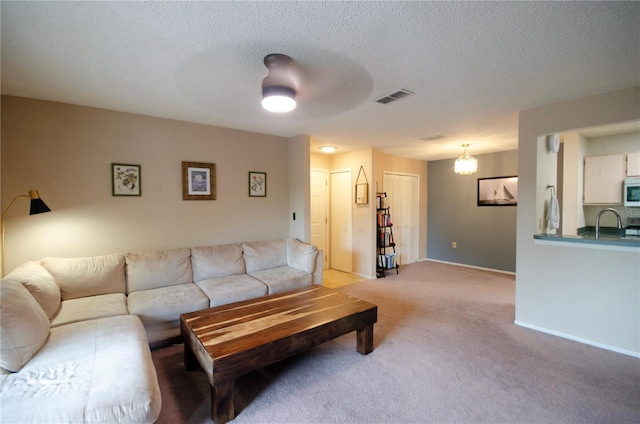 3705 SW 27th St Unit 223, Gainesville, FL 32608 - living area featuring light colored carpet and a textured ceiling