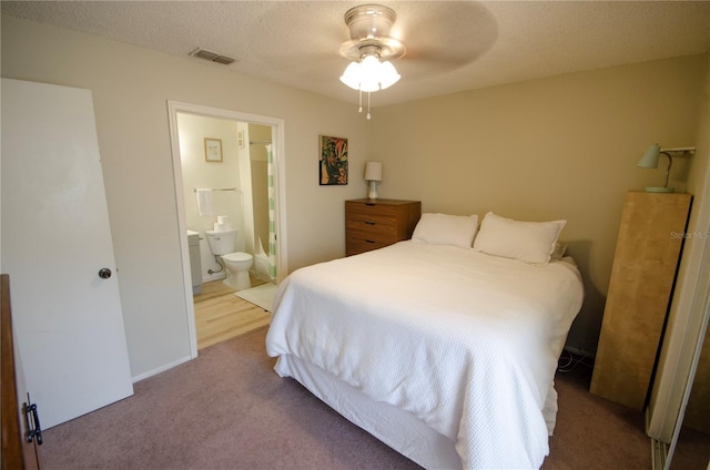 3705 SW 27th St Unit 223, Gainesville, FL 32608 - carpeted bedroom with ensuite bathroom, a textured ceiling, and a ceiling fan