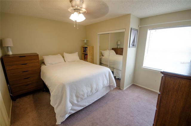 3705 SW 27th St Unit 223, Gainesville, FL 32608 - carpeted bedroom with a closet, ceiling fan, and a textured ceiling