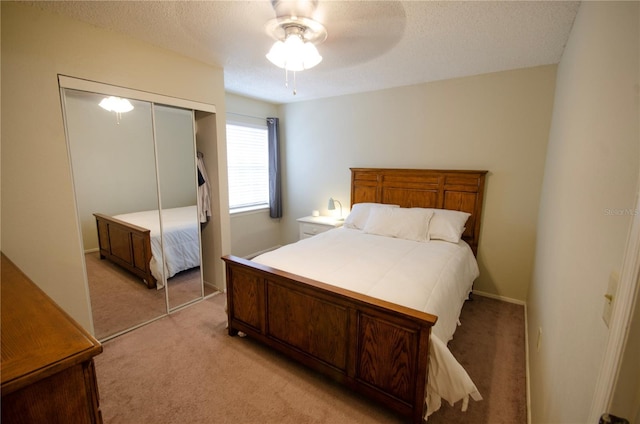 3705 SW 27th St Unit 223, Gainesville, FL 32608 - bedroom featuring light colored carpet, a closet, a textured ceiling, and ceiling fan