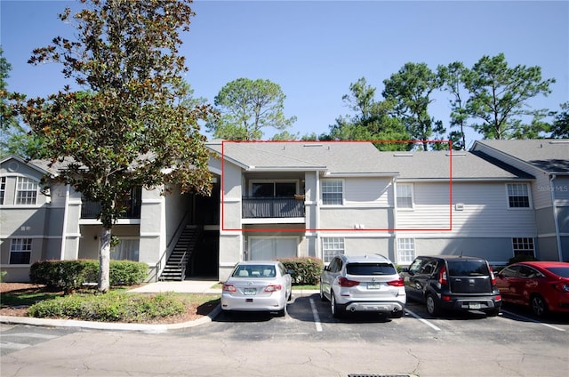 3705 SW 27th St Unit 223, Gainesville, FL 32608 - view of building exterior featuring uncovered parking and stairway