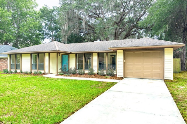 1745 NW 42nd Ave, Gainesville, FL 32605 - single story home with a front yard, a garage, driveway, and a shingled roof