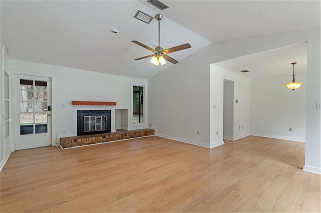 1745 NW 42nd Ave, Gainesville, FL 32605 - unfurnished living room featuring vaulted ceiling, light wood finished floors, a ceiling fan, and a fireplace