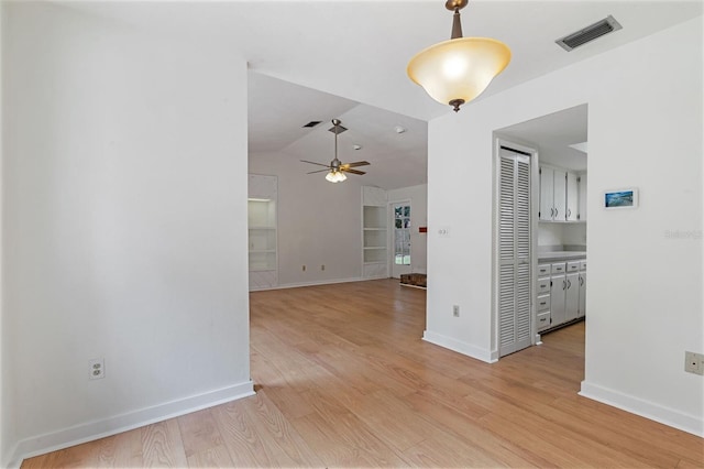 1745 NW 42nd Ave, Gainesville, FL 32605 - unfurnished room featuring ceiling fan, light wood-style floors, and vaulted ceiling
