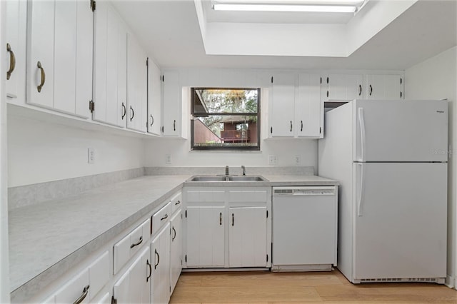 1745 NW 42nd Ave, Gainesville, FL 32605 - kitchen with white appliances, light countertops, white cabinets, light wood-type flooring, and a tray ceiling