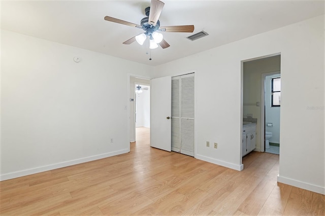 1745 NW 42nd Ave, Gainesville, FL 32605 - unfurnished bedroom featuring light wood-style floors, a closet, connected bathroom, and a ceiling fan