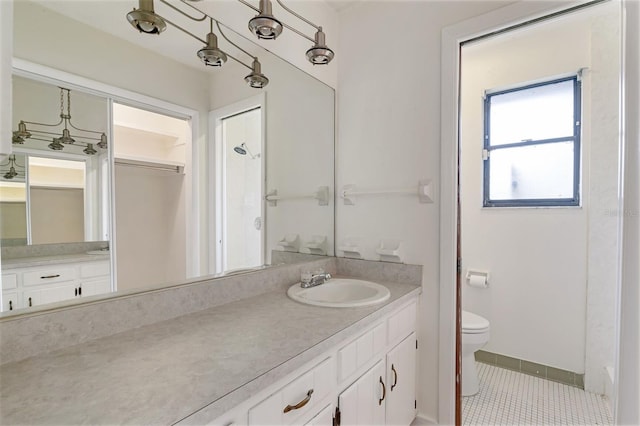 1745 NW 42nd Ave, Gainesville, FL 32605 - full bath with vanity, tile patterned flooring, and a walk in closet