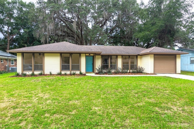 1745 NW 42nd Ave, Gainesville, FL 32605 - single story home featuring a sunroom, an attached garage, driveway, and a front yard