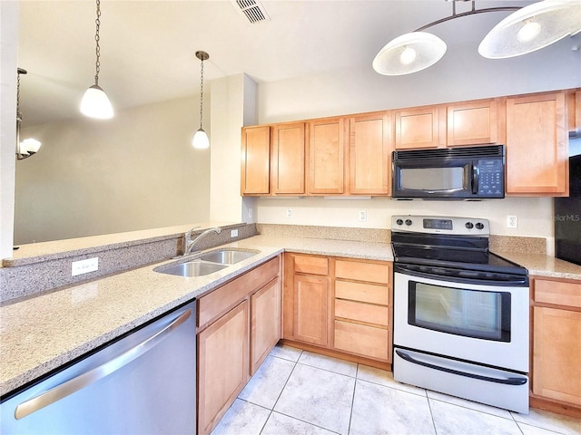 2508 SW 35th Pl Unit L-70, Gainesville, FL 32608 - kitchen with appliances with stainless steel finishes, light brown cabinets, light tile patterned floors, and light stone countertops