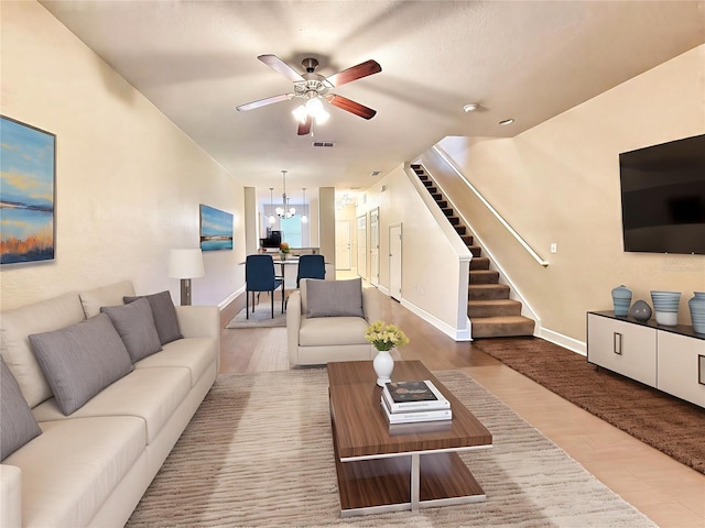 2508 SW 35th Pl Unit L-70, Gainesville, FL 32608 - living room with stairway, wood finished floors, ceiling fan, and a chandelier