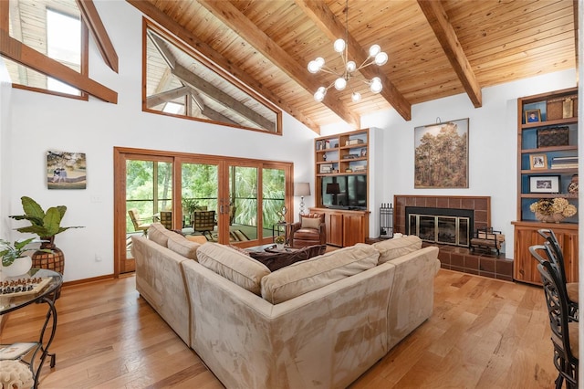 6501 NW 16th Pl, Gainesville, FL 32605 - living area featuring light wood finished floors, a wood ceiling with exposed beams, a tiled fireplace, high vaulted ceiling, and a chandelier