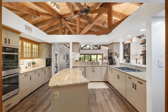 6501 NW 16th Pl, Gainesville, FL 32605 - kitchen with appliances with stainless steel finishes, a wooden ceiling with exposed beams, a ceiling fan, dark wood finished floors, and a center island