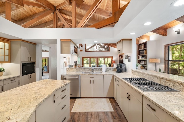 6501 NW 16th Pl, Gainesville, FL 32605 - kitchen with appliances with stainless steel finishes, wood ceiling, wood finished floors, recessed lighting, and light stone countertops