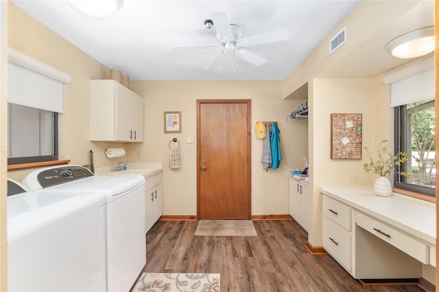 6501 NW 16th Pl, Gainesville, FL 32605 - laundry room featuring cabinet space, separate washer and dryer, wood finished floors, and a ceiling fan