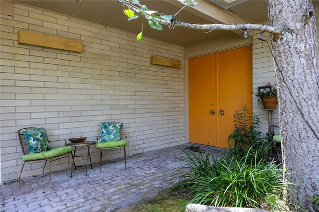 2010 NW 32nd Ter, Gainesville, FL 32605 - doorway to property with brick siding and a patio area