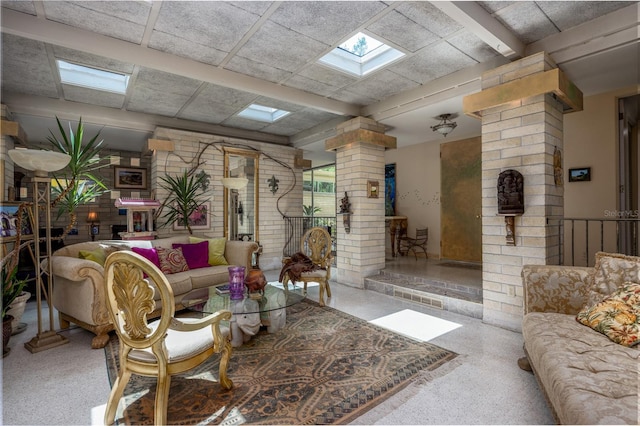 2010 NW 32nd Ter, Gainesville, FL 32605 - living area featuring ornate columns, a skylight, and speckle patterned floor