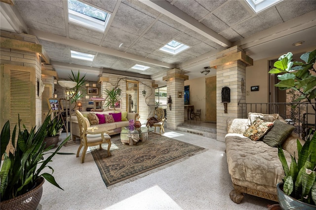 2010 NW 32nd Ter, Gainesville, FL 32605 - living area with ornate columns, a skylight, and speckled floor